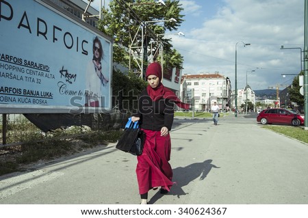 Muslim woman on street/Muslim woman in traditional islamic outfit walking down the streets of Sarajevo during the month of holy Ramadan. Sarajevo, Bosnia and Herzegovina, July 16, 2013