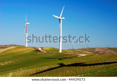 Vertical axis wind turbines and shadows on top of a hill