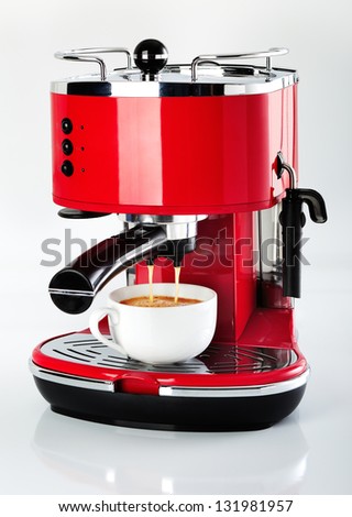 A red vintage looking espresso coffee machine is making a coffee on a white background A red vintage looking espresso coffee machine is making a coffee on a white background