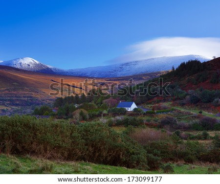 A scenic view of a snowy Kerry Mountains and surrounding areas in County Kerry, Ireland.