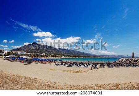 Beach in Puerto Banus, Marbella, Spain. Marbella is a popular holiday destination located on the Costa del Sol in the southern Andalusia, it lies beneath the Cordillera Penibetica mountains