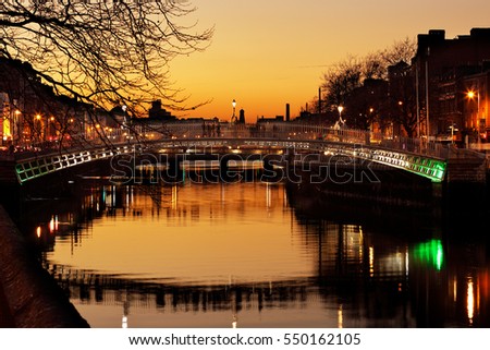 Ha'penny Bridge and the north banks of the river Liffey in Dublin City Centre at night. Ha'penny Bridge is a pedestrian bridge built in 1816 of cast iron