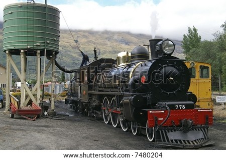 Vintage steam train fetching water