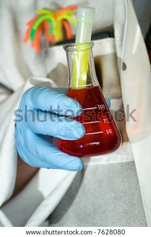 Mad scientist holding a flask with red fluid