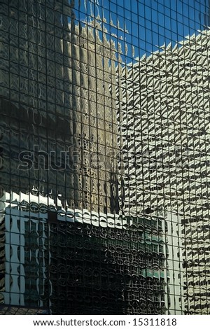 Office building reflecting in mirrored skyscraper windows