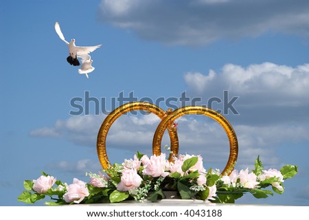 stock photo Rings symbolizing wedding on a background of the lightblue 