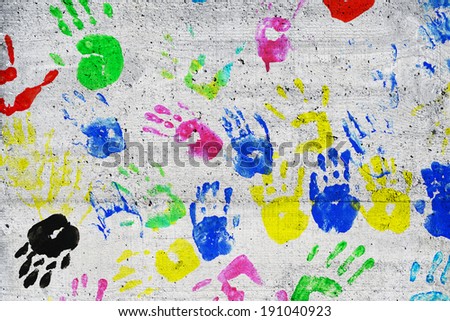 colorful kids handprints on concrete wall detail