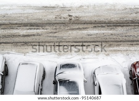 parking lot with cars covered in snow detail view from above