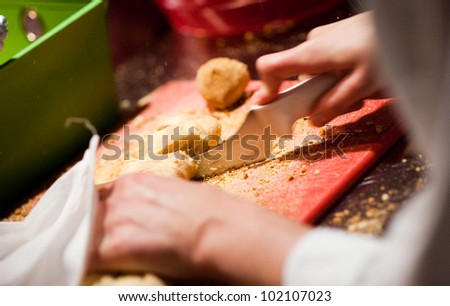 Slicing French bread in a commercial kitchen