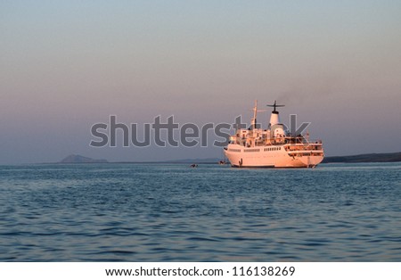Cruise ship at anchor at sunset in Ecuador
