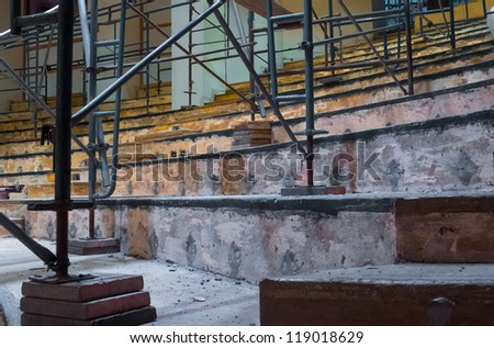 Wooden scaffolding set up indoors on concrete steps