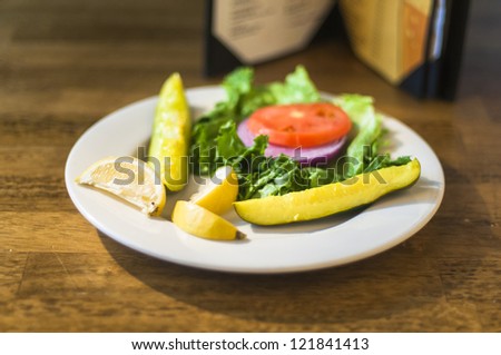 Pickles, lettuce, tomato, onions, lemon for hamburger