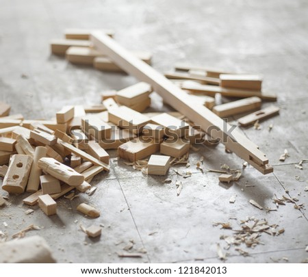 Cut wood pieces on the floor of a workshop