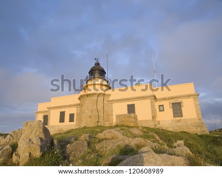 Lighthouse built on a building at sunset. Lighthouse built on a building at sunset. The lighthouse is bathed in evening light and is located in Ferrol, Galicia, Spain.