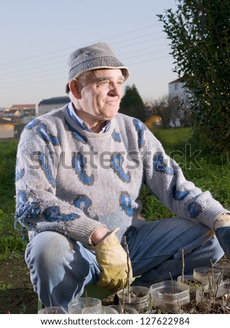 Farmer sitting and looking sideways in a flash strobist shot