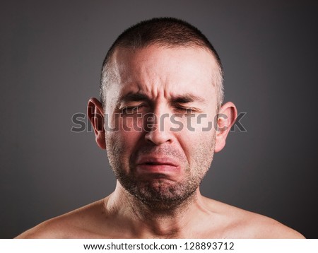 Crying man isolated on black background.