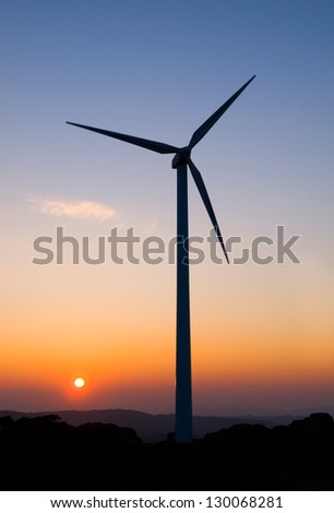 One wind turbine at dusk in vertical composition.