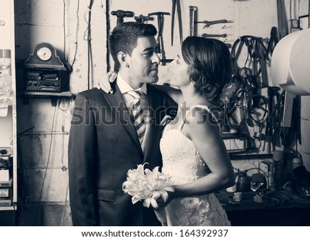 Bride and groom inside a garage in black and white