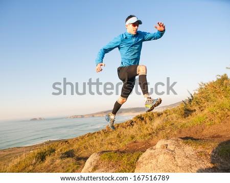 Man Practicing Trail Running With A Coastal Landscape In The Background