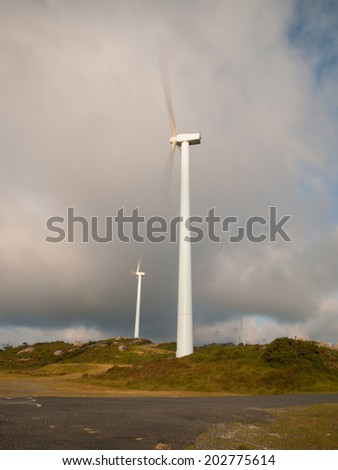 Two wind turbines in vertical composition.