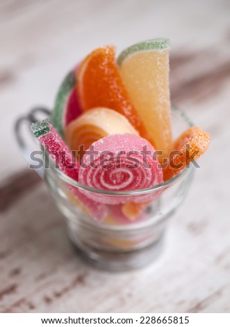 jelly beans in a glass cup in a macro shot.