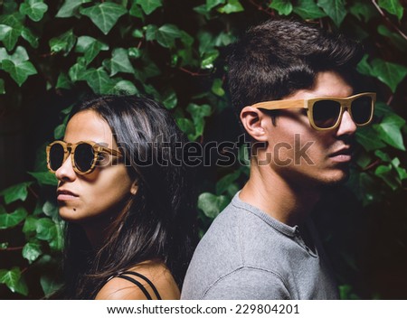 Man and woman with sunglasses in a flash shot outdoors