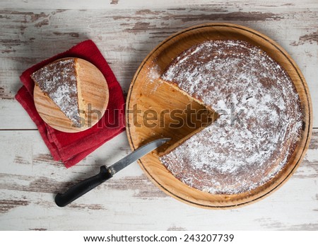 Sponge cake of lemon over wooden background in an overhead shot
