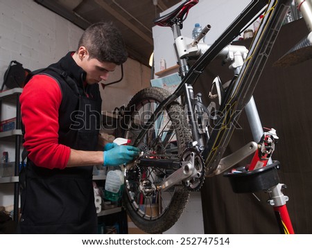 Mechanic repairing a mountain bike in a workshop