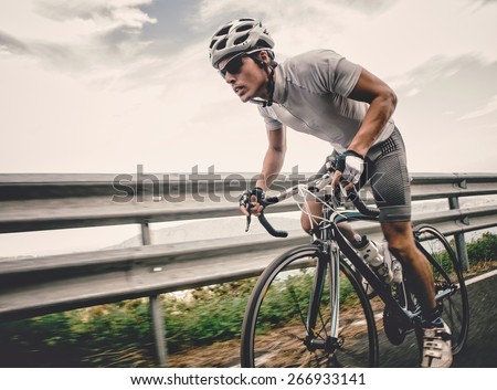 Cyclist in maximum effort in a road outdoors