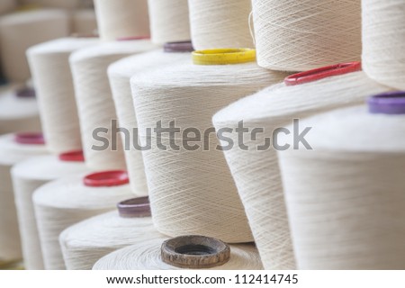cotton threads cone stacked together in a factory