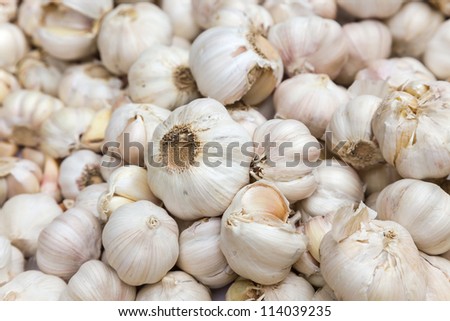 raw white garlic stacked in a local market, photo taken in south east China.