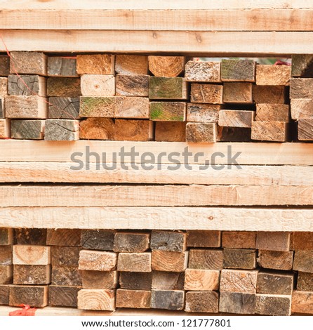 lumber cross stacked together in the lumber factory