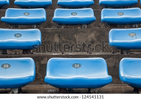 blue rubber seats in a sport stadium in the out door under rain, with wet seats