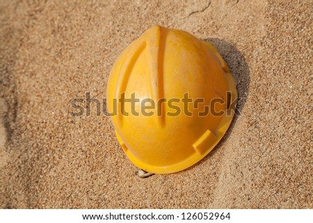 hardhat on top of sand in a construction site