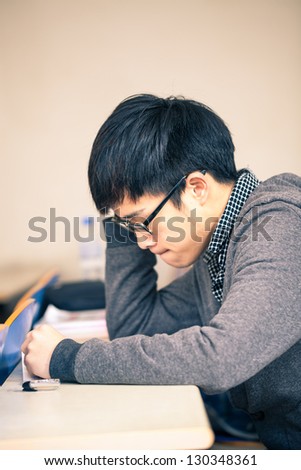 asian chinese student studying in the classroom