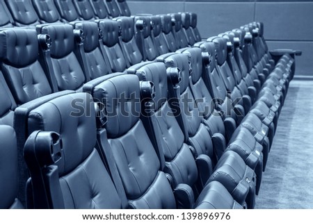 black armchairs in the cinema ordered
