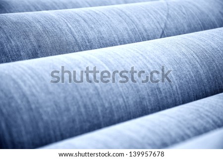 reel of jeans cloth stacked in the factory