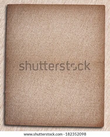 Close up of old  paper front side grunge with space for text or image  isolated with clipping path on brushed brown and white background