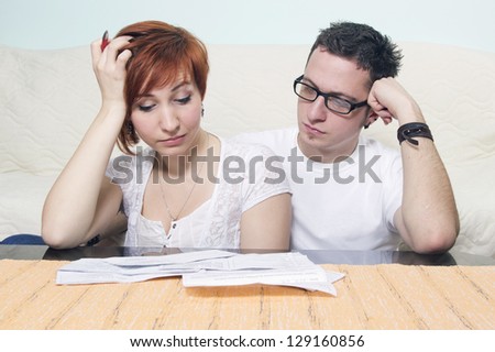 Unhappy young couple in financial trouble at home
