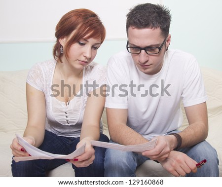 Unhappy young couple in financial trouble at home