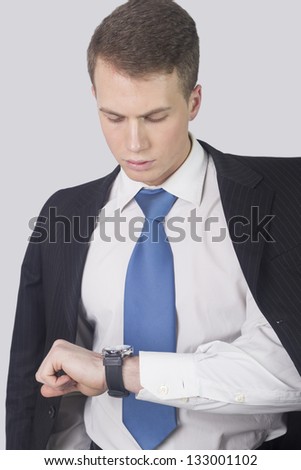 Businessman checking the time on his wristwatch.