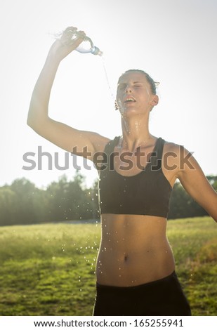 Girl is refreshed with water after training