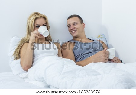 Young couple in the bad drinking coffe