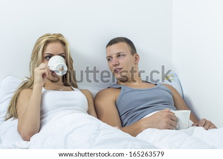 Young couple in the bad drinking coffe