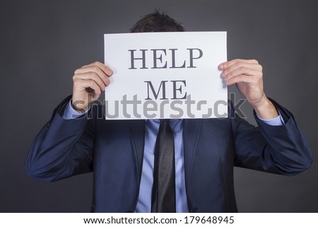 Businessman holding paper which written Help Me
