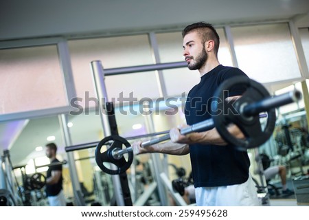 Handsome Muscular Men Performing High Intensity Bicep Curls With Barbell