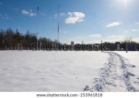 trodden road in snow to meteorological station