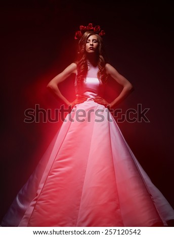fashion look bride in a hoop from roses and in a gentle red flames flame