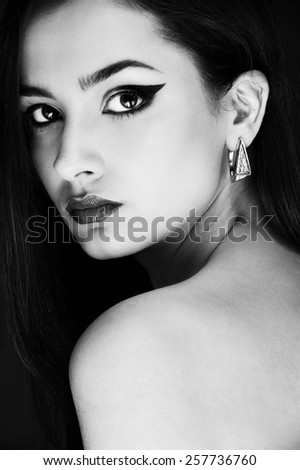 luxury beauty brunette girl with diamond ear rings black and white portrait