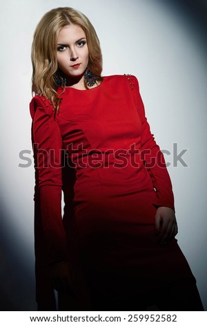 young fashion model woman in red dress with fashion make up and red lips